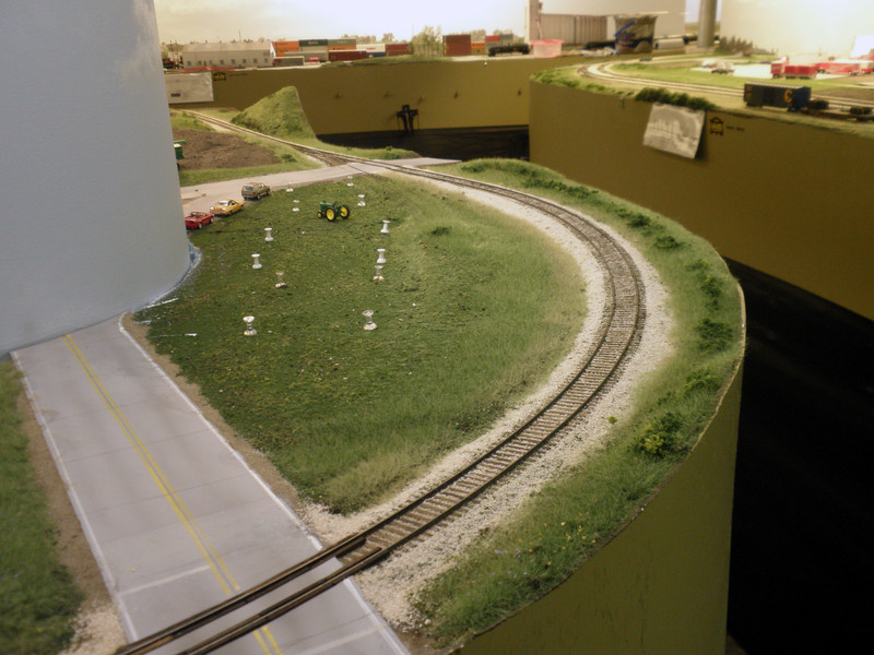 Looking west at McClelland.  The push pins were used to identify future structure locations.  Road weathering throughout the layout was done with a combination of diluted India ink, Pan Pastels, and pencil lead.