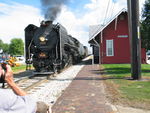 Steam train leaves Geneseo; the train is going away from us.