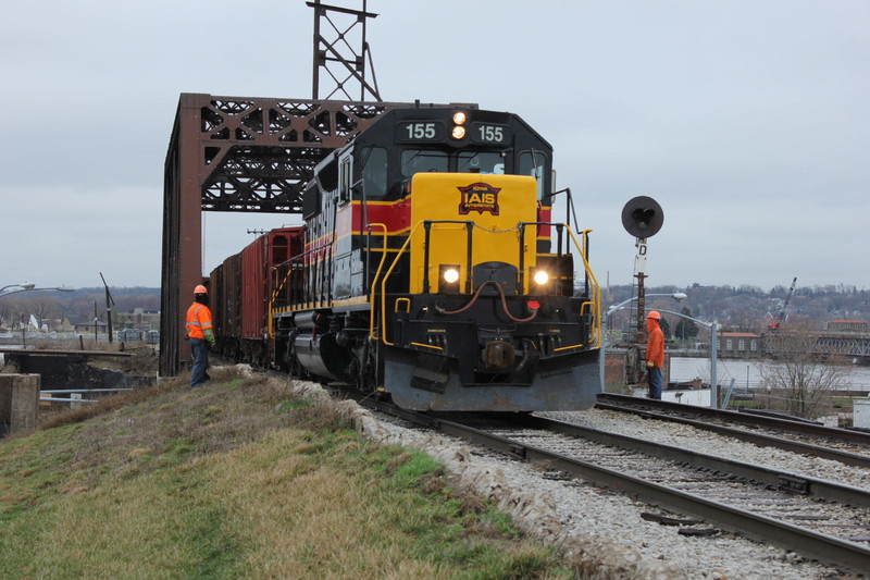 Ballast train is  heading west across 3rd St.