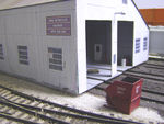 This red "scrap only" dumpster is kind of a fixture at the Bluffs shop, as seen in the above prototype photo.  It's kitbashed from a small dumpster from the Walthers #3516 dumpster set, cut shorter in length, with added details from styrene and gears from an old Athearn locomotive.  The lettering is from a Microscale alphabet set.