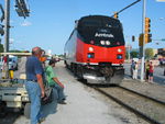 Cousin Greg and Uncle John admire Amtrak heritage units backing across 18th St. after 765 has cut off the train.