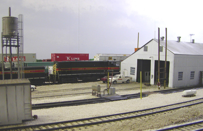 Diesel pad looking NW.  The white tank laying on pallets toward the right was a new arrival in my era, brought in to replace a tank on the fuel pad pump house, but not installed until a short while after my timeframe.  It can be seen in the prototype pic at the bottom center of this page.