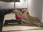 "Before" view from 2007, showing the combined Storage/McCollister track with the ancient red Katy used oil tank car.  Directly to the right of that car was a 5-1/2" space between the frog gap of West 1 switch on the right and the points of Track 2 switch on the left. That gap turned out to be all I needed to solve my problem.