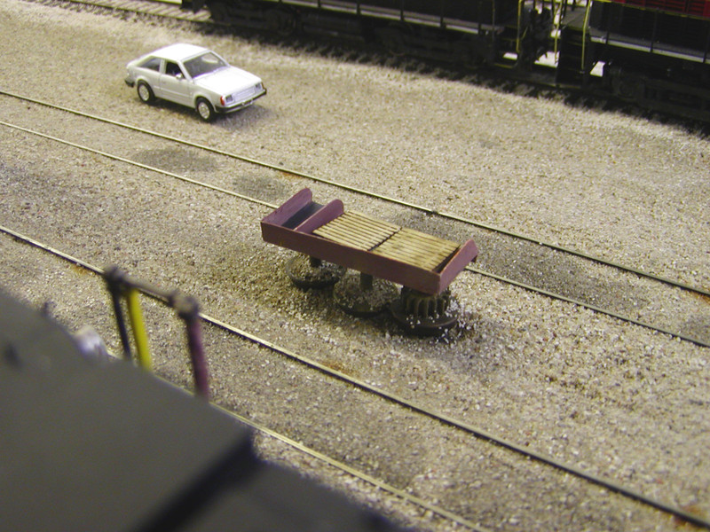 Shop table after paint, weathering, and ballast applied around the feet.