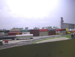 Looking west toward Bluffs Yard and the Hansen-Mueller elevator.  H-M was served by the Council Bluffs Great Western (CBGR) during my era, but is now an IAIS customer due to IAIS's 2006 acquisition of CBGR.  Immediately to the left of Hansen-Mueller, barely visible through the trees, is the white Bartlett elevator, served by BNSF.