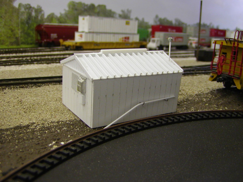 Scratchbuilt MOW shed looking NW.  Electrical box is from SS Ltd., while the screen over the window is Scale Scenics #3500 aluminum micro mesh.  Bulk of the structure is Evergreen stock, with the walls scribed to represent the prototype's panels.  The roof ribs were cut from 1/16" C-channel.