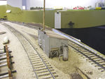 Looking north at the model.  The vertical tank was cut from the end of a Bic pen.  On the west side, the electrical meter was a Scale Structures part (#2332) and the doors were scratchbuilt.