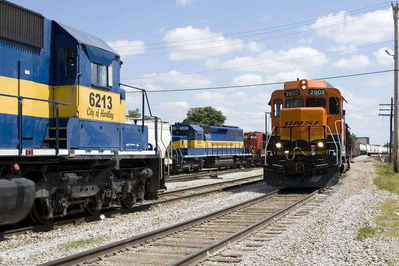 BNSF's Barstow job passes power for a syrup train (ICE 6213) and the Nitrin local (ICE 114) @ Rock Island, IL.