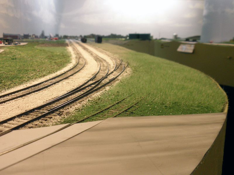 Looking west from Linn St., with the Stock Track disappearing into the grass, out of service.  The road and adjacent scenery are still in progress.