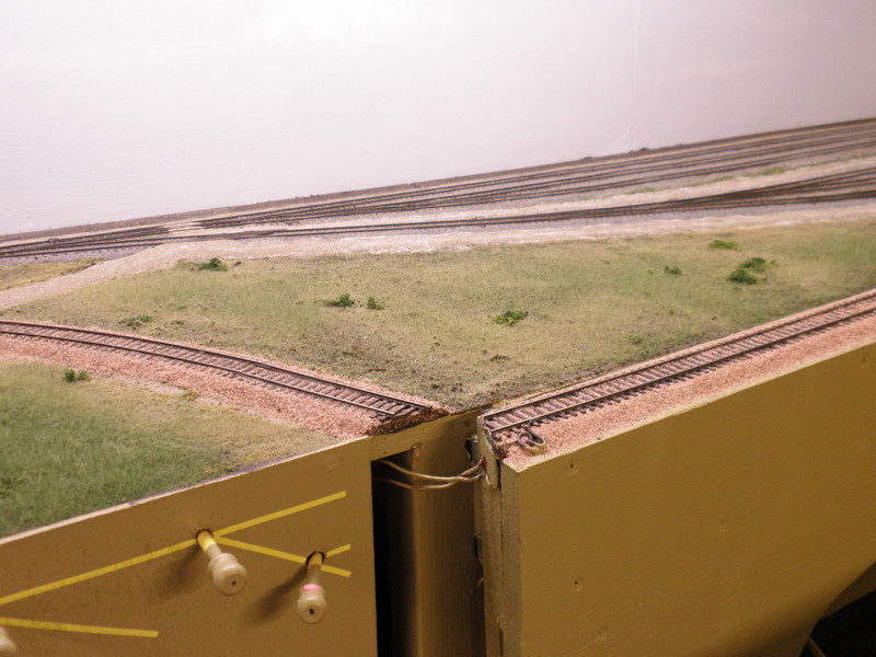 Starting at the west end of the scene, this view shows the east end of UP's Pool Yard.  The track with the pink ballast in this image and the next one is the lead to North Pool Yard, where the stack train is located in the Bing image.  On the layout, I only had space for the south portion of the yard, so this track leads across the aisle to West Staging.