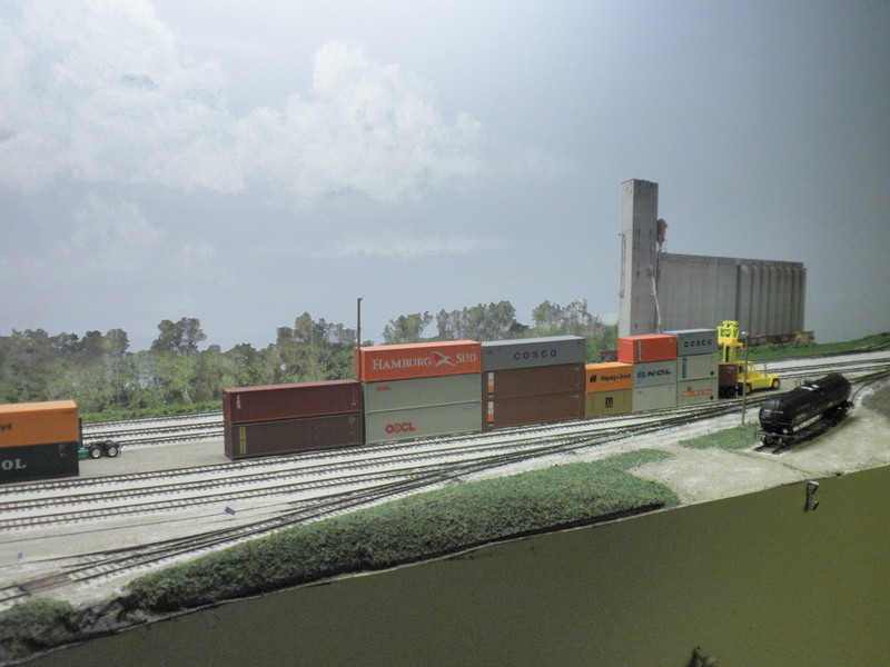 Recent progress in front of Bluffs yard.  I added the little hill that overlooks the north end of the enginehouse, reworked the parking light to its right, and realigned the Tanner spur to more closely match the prototype.