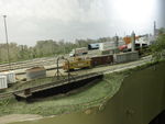 Looking NW at the turntable, yard, and engine service area.  The static grass is a mix of 4mm and 6mm Autumn to represent the tall dead grass in the turntable pit and surrounding area.  

The UP caboose was owned by a private individual and stored on the IAIS.  It was gone by my era, but the model was a gift from my wife and my one and only brass model, so I wanted to keep it on the layout.

I obviously have some touch-up work to do on the fascia now that I'm done with the scenery here. :-)
