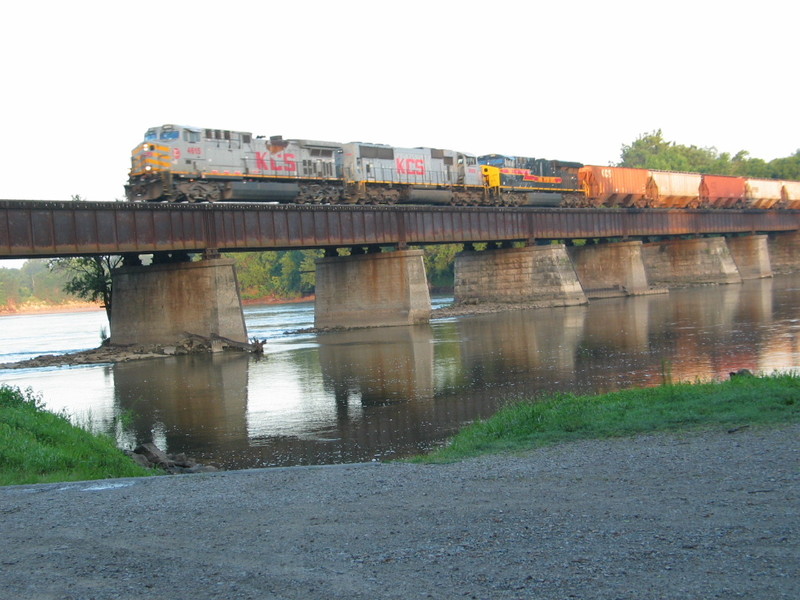 EB KCS detour crosses the Cedar with an IAIS Gevo, Aug. 9, 2011.  The sun was still just a little low here unfortunately.