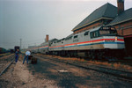 Amtrak 409 and 353 with a 5 car train at the Rock Island depot on a rainy day in 1987