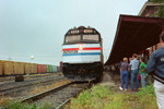 Passengers disembarking in the background, while some of the railfans look on