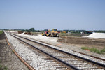 Looking west from 2900E crossing.  New rail ready for mainline and land graded for new yard north of mainline and siding.   August 10, 2007.