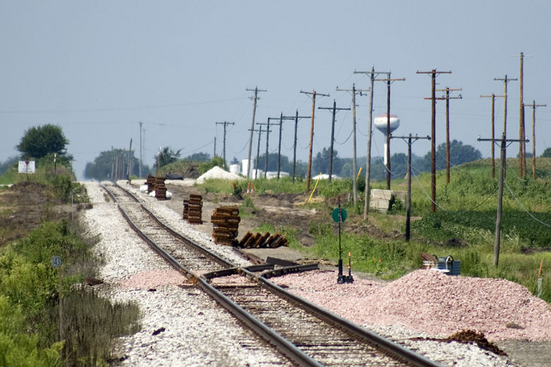 Looking west at the east siding switch, located at the Henry/Bureau County line.  Steel ties stacked and waiting for placement for new siding.   August 10, 2007.
