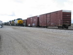 EB passes damaged boxcars parked on the Atalissa fertilizer track.