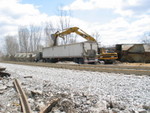 They're now loading beans (and dirt) with a trackhoe, in addition to the vacuum truck.