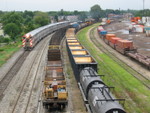 West train prepares to depart Blue Island as an inbound Metra flies by on the main.  Looking south from 127th St., Aug. 29, 2006.