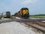 East train at the newly replaced Durant Iron and Metal crossing, sitting while the cond. walks the brake test.  Those are potash empties waiting for pickup, sitting on Twin States Engineering's spur to the left.