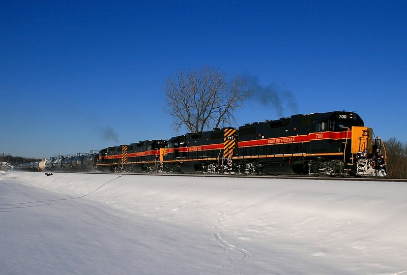 IAIS 700 roars past New Lenox Metra Station as the morning sun makes an appearance after a 6" snow storm the night before