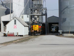 IAIS 709 emerges from under the loading spout at Hancock Elevator, where BICB has stopped to pull seven loads from the tail track that extends north from the elevator.