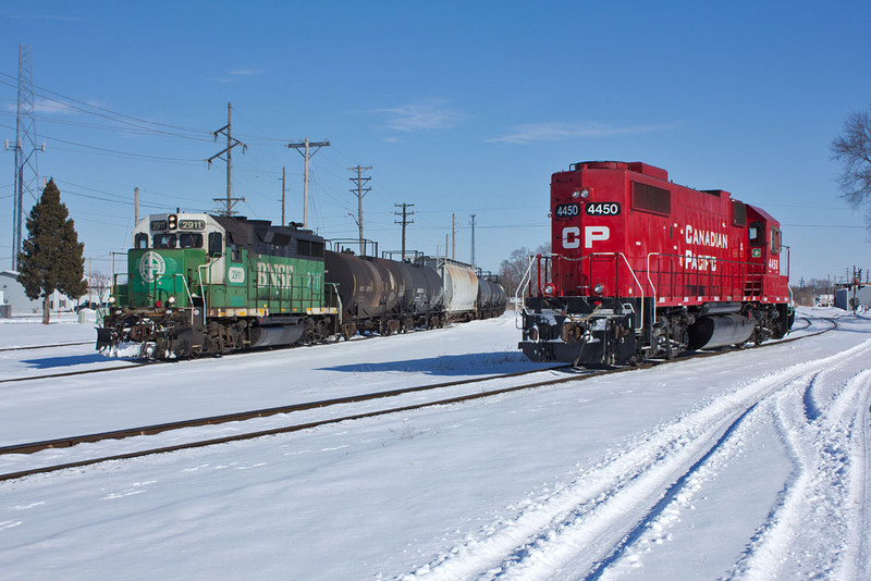 CP's B73 waits on the IAIS while BNSF's 427 job west west.  7th St; East Moline, IL.