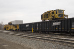 BNSF's Plasser American Tie Machine @ 44th St; Rock Island, IL. The machine on top of the gondola brings new ties to the tie installer.  March 25, 2009.