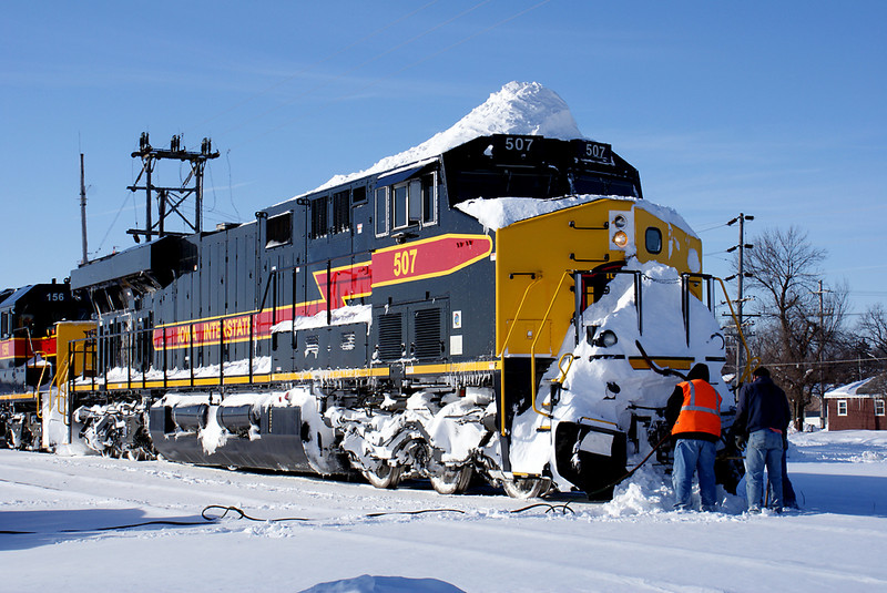 Cleaning snow from the front coupler. The 507 is down to one working headlight from hitting heavy snow drifts.