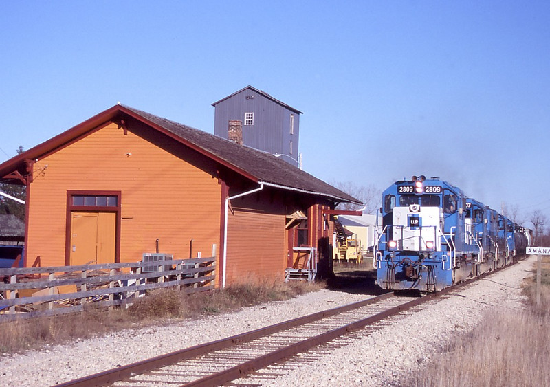 The 2809 is leading the quartet of LLPX SD38-2s past the Amana, IA depot on its way back to Iowa City.  Photo by Will Rasmussen.