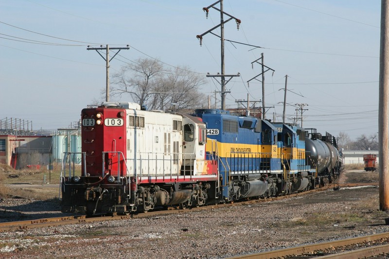 And the oldest diesel of the day goes to the leader of the IC&E local - GP9 #103.  Here, the local waits to use the single track at East Moline