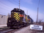 IAIS 468 West with BUSW-09 passes the north entrance to NRE at Silvis Transfer on 09-Apr-2004.