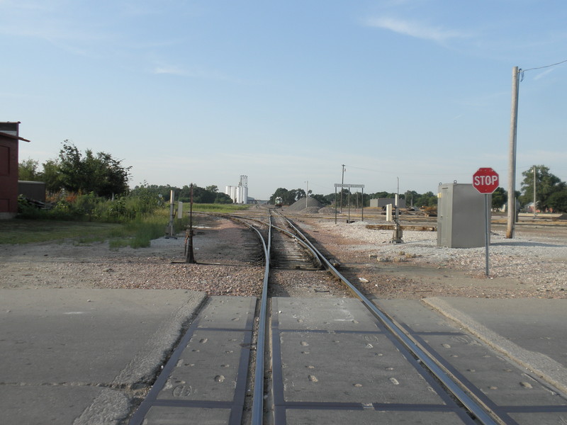 To the west is the IAIS/BNSF crossing, the view of BNSF's Council Bluffs yard and, in the distance, the Bartlett grain elevator and I-80/I-29 overpasses.  Prototype, August 11, 2013.