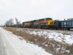 East train pulls past the Wilton Pocket, slowing down to stop and set out scrap loads on the head end.