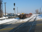 The east train clears the main at Vermont St., while the CRL is coming out of Roll Lumber in the background.