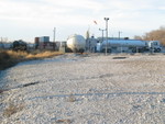 The switch crew is using their stacks from West Yard as a "handle" while switching Anhydrous tanks at Tanner Ind.  The black tank car at left is an empty that was just pulled; the white car is a load being spotted.