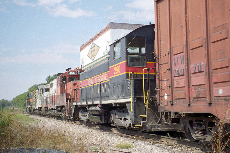 IAIS 250 tags along on BICB-03 at Taylor St in Davenport, IA.  September 4, 1999.