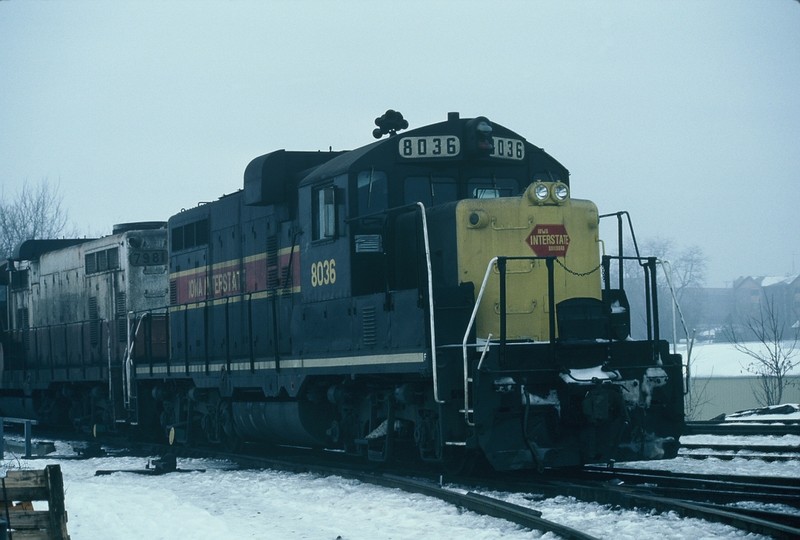 8036 (436) in it's original new paint and 4-digit number works the Iowa City yard on 14-Feb-1986. Of interest is the red hexagon herald, frog eye headlamps, and the red lense on the lower upper headlight, and of course, the "standard" duct tape over the cab vent.
