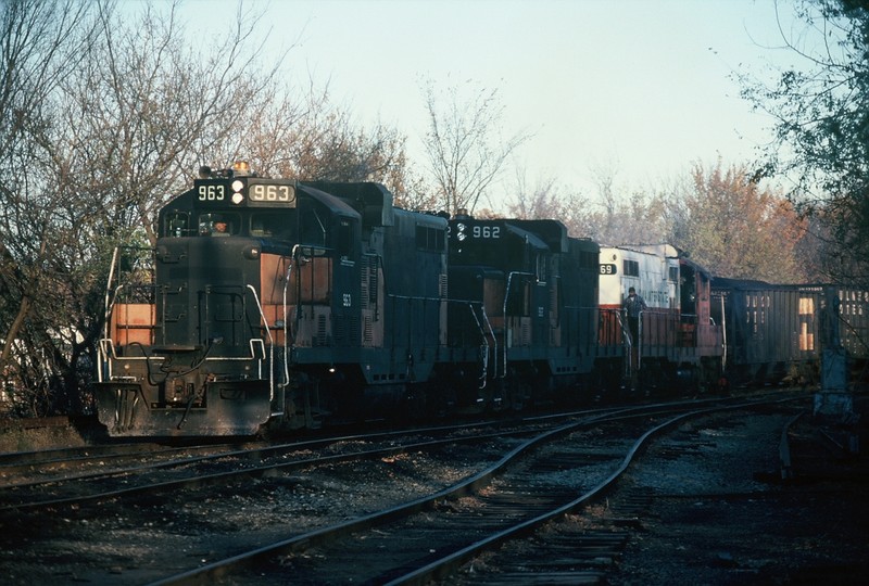 Ex-Milwaukees GP-20's 963 and 962 along with 469 getting ready to push a load of coal down the Hill Track to interchange with the CIC. Nov-1988.