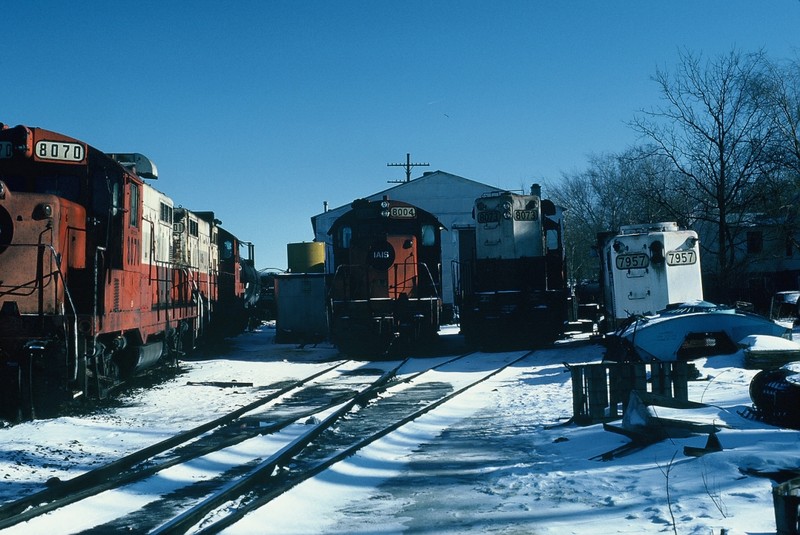The west end of the engine house in Iowa City 5-Jan-1986. Note the dynamic brake unit (used for load testing generators and engines) to the right of the picture in front of 7957's hood.