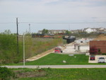 East train shoving sand into Ozinga, mp 27, Mokena.  April 25, 2006.