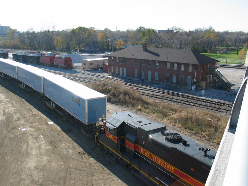Looking southwest from 127th St.; the road power has tied onto the pigs, ready to pull.  The building is the old RI Chicago Terminal Division headquarters, now used by Metra.  Nov. 3, 2006.