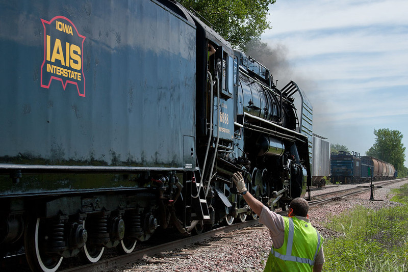 Conductor Stan highballs IAIS 6988.  North Star; Wilton, IA.