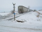 Westbound clears the gravel crossing west of Atalissa.  Note the new rail laid the other day....
