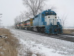 Backing through the crossover to their train, after cutting off the setout cars on the pocket.