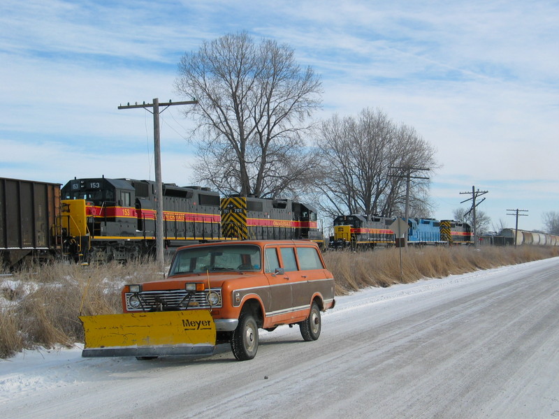 RI turn meets the coal empties at N. Star.  Sorry about the Farmall blocking the view- I just couldn't resist that pose!  Feb. 7, 2007.