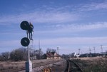 Looking east at the east end of West Lib. siding, 11-3-85.  The former West Lib. yard lead is visible heading off into the weeds at right.  Ron Reynolds is perched on the EB home signal to get the shot!