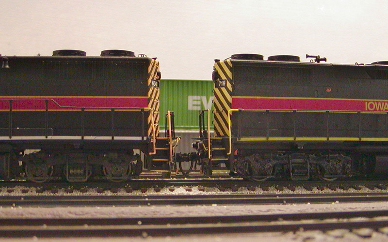 IAIS GP38-2 719 back-to-back with an Atlas factory GP38, more clearly illustrating the deck height comparison.

This conversion was a snap, and accomplished everything I'd hoped it would.  It took less than two hours, and that was with all the trial and error fitting, disassembly, adjustment, and refitting. Now that I know what to do, I think I could complete it in around 30 minutes or so.