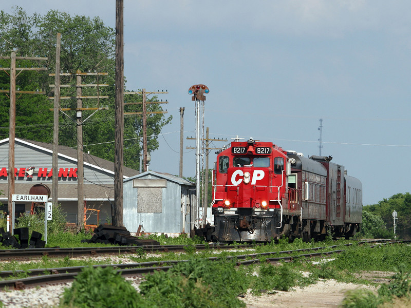 CP 8217 West passes the old Rock Island depot at Earlham, IA on 7-Jun-2005.